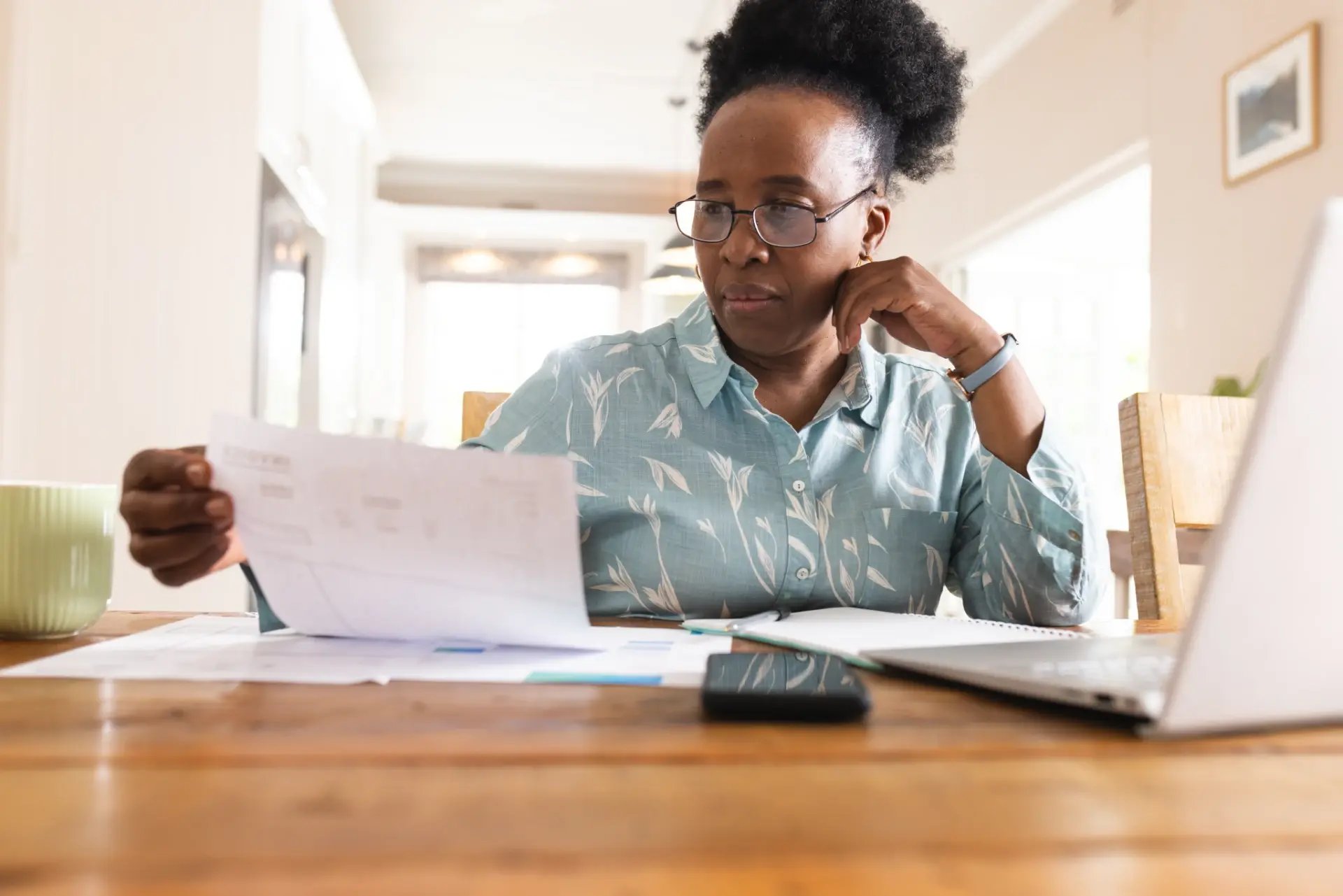 woman-reviewing-documents-at-wooden-table-indoors-2026-03-25-06-31-09-utc