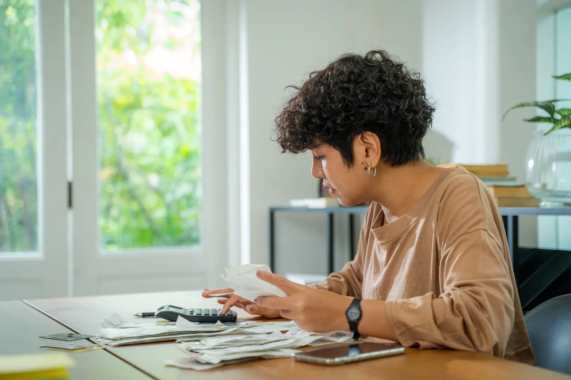 young-adult-finances-at-home-with-calculator-2026-03-17-07-20-25-utc