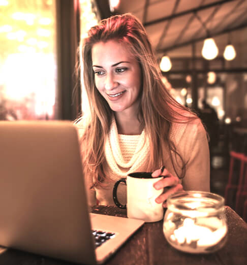 Woman sitting at computer - AccountingWEB state of the nation report